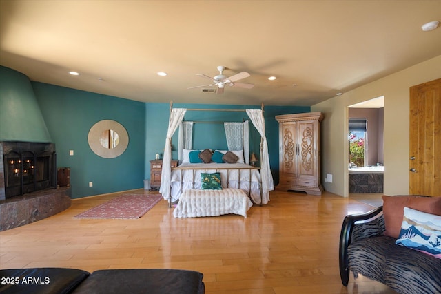 25483 N Wrangler Rd, Scottsdale, AZ 85255 - bedroom featuring recessed lighting, wood finished floors, a fireplace, and ceiling fan
