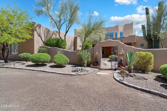 25483 N Wrangler Rd, Scottsdale, AZ 85255 - view of front of house with a fenced front yard, stucco siding, and a gate