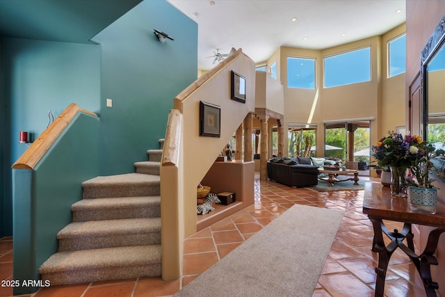 25483 N Wrangler Rd, Scottsdale, AZ 85255 - staircase with tile patterned flooring, a high ceiling, and recessed lighting