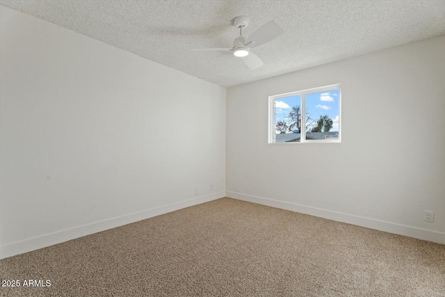 carpeted spare room featuring ceiling fan and a textured ceiling