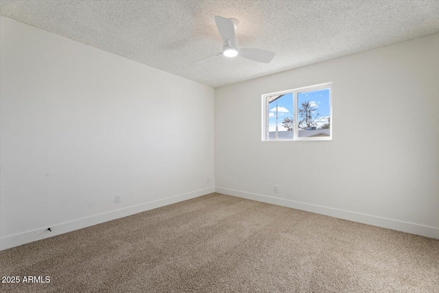 carpeted spare room with a textured ceiling and ceiling fan