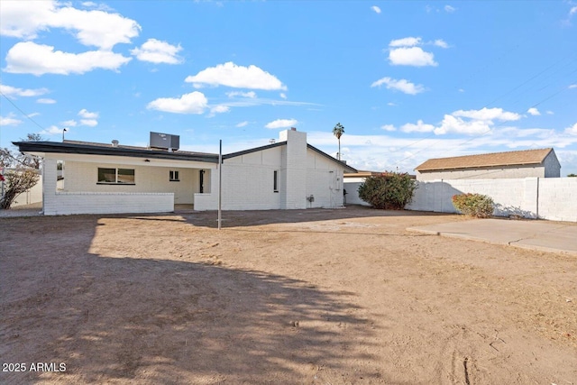 back of property with cooling unit and a patio