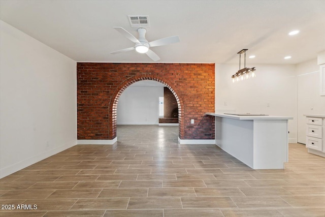 kitchen with a breakfast bar, white cabinetry, decorative light fixtures, kitchen peninsula, and ceiling fan