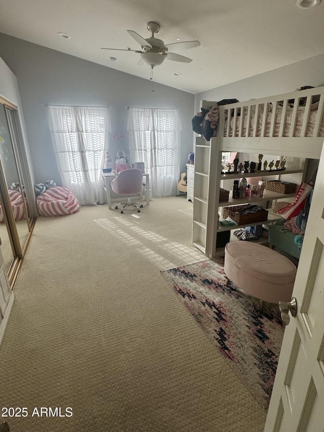 bedroom with a ceiling fan, carpet, and lofted ceiling