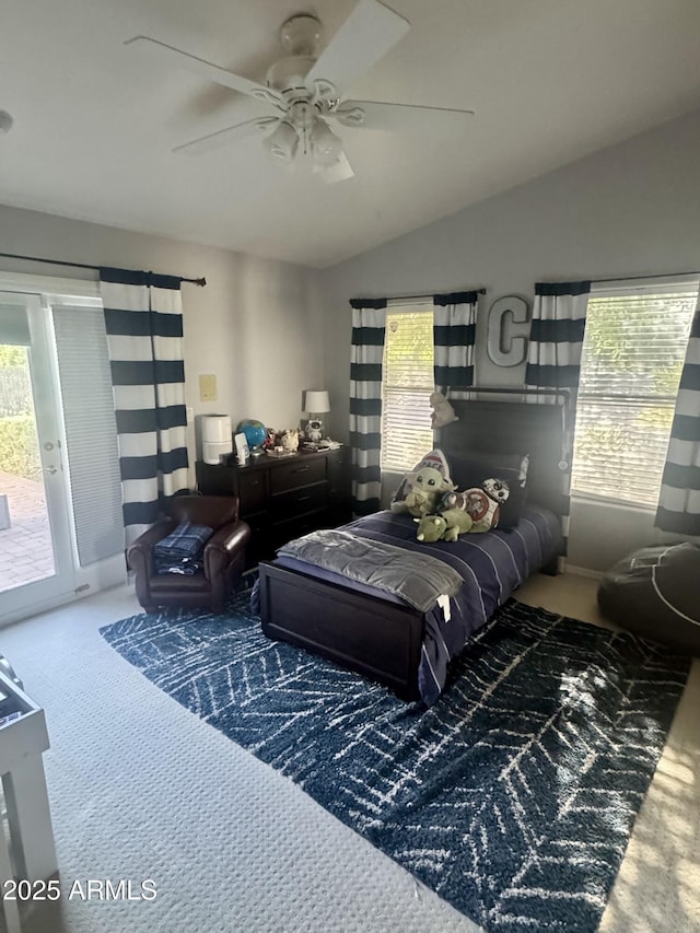 living area featuring a wealth of natural light, a ceiling fan, carpet flooring, and vaulted ceiling