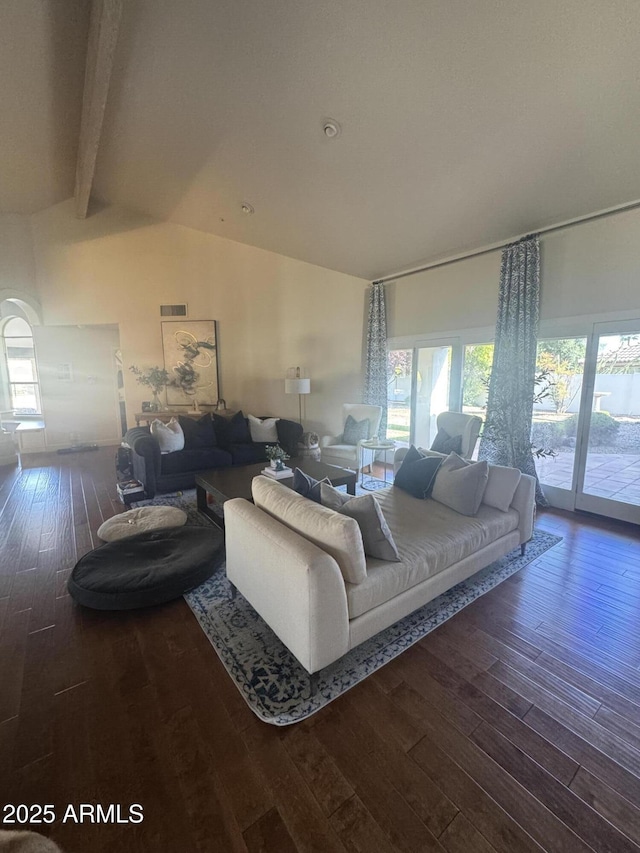 living room featuring plenty of natural light, hardwood / wood-style floors, and vaulted ceiling with beams