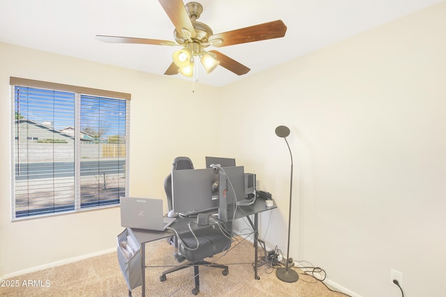 carpeted office featuring ceiling fan