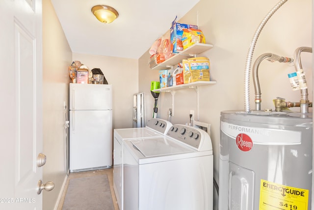 washroom with washing machine and clothes dryer and electric water heater