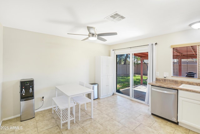 kitchen with white cabinets, light tile patterned floors, dishwasher, and ceiling fan