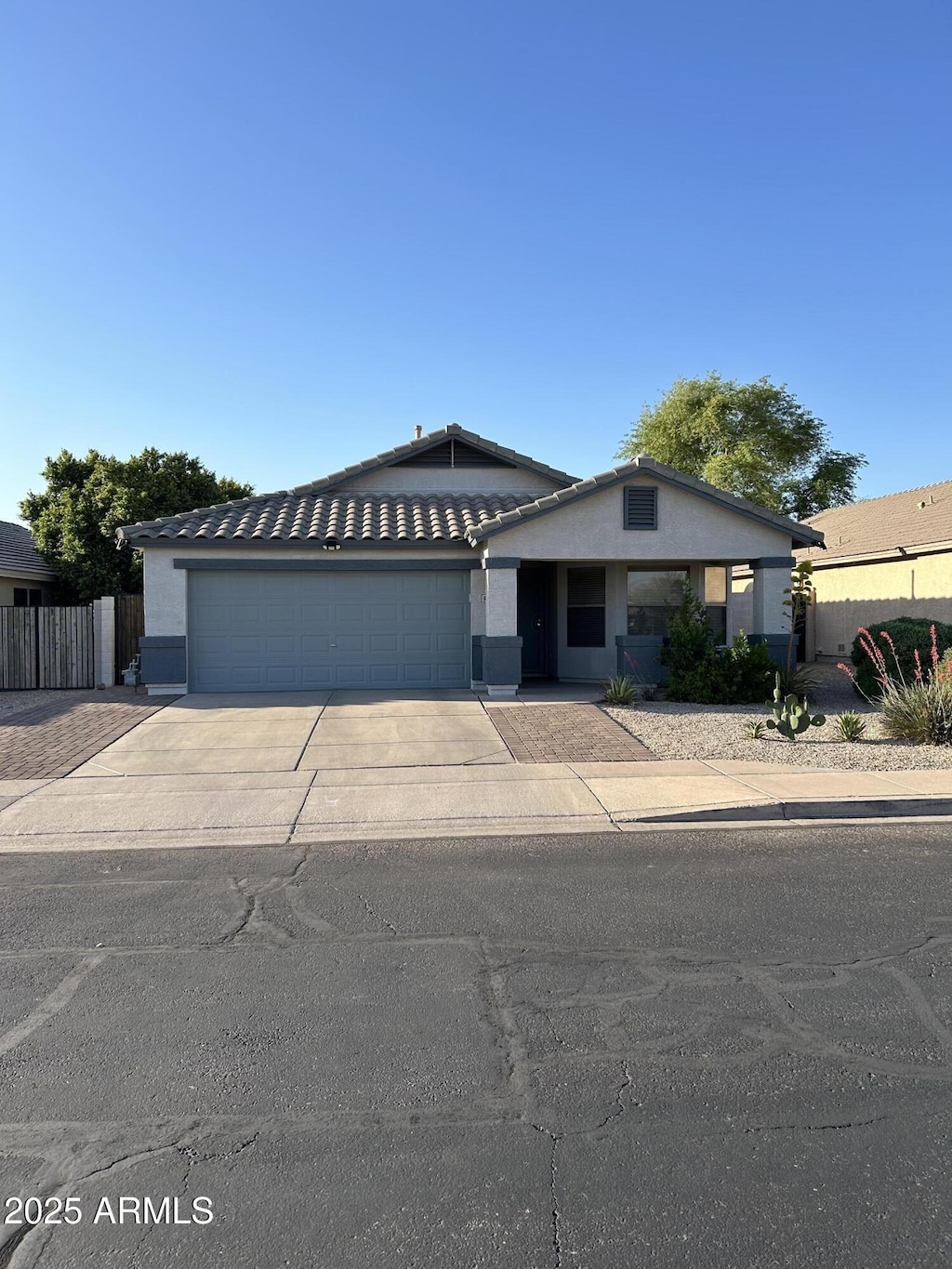 view of front of home with a garage, stucco siding, and concrete driveway