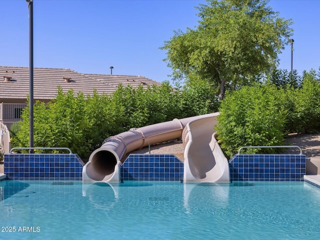 view of swimming pool featuring a water slide