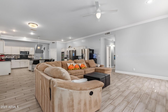 1442 W Laurel Ave, Gilbert, AZ 85233 - living room featuring ornamental molding, ceiling fan, light wood-style floors, arched walkways, and baseboards