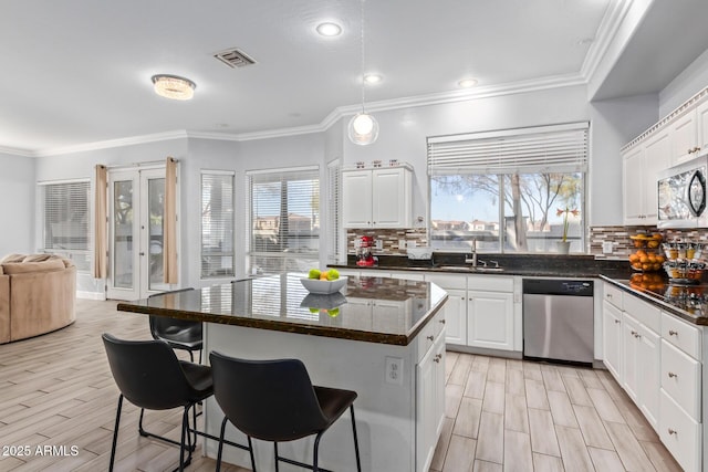 1442 W Laurel Ave, Gilbert, AZ 85233 - kitchen with stainless steel appliances, plenty of natural light, a sink, backsplash, and crown molding