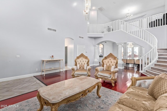 1442 W Laurel Ave, Gilbert, AZ 85233 - living area featuring arched walkways, ornate columns, stairs, a towering ceiling, and baseboards