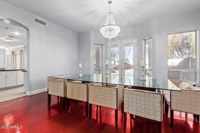 1442 W Laurel Ave, Gilbert, AZ 85233 - dining space featuring wood finished floors, arched walkways, a chandelier, and baseboards