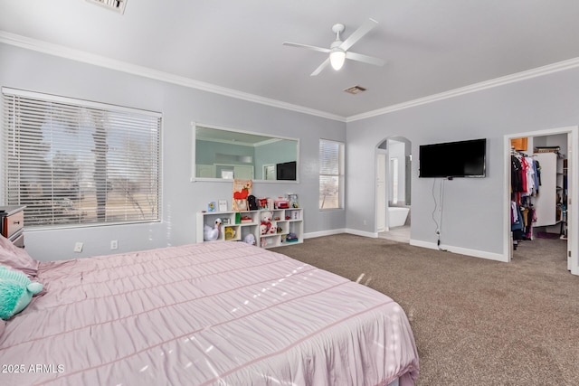 1442 W Laurel Ave, Gilbert, AZ 85233 - carpeted bedroom featuring crown molding, baseboards, arched walkways, a spacious closet, and ensuite bathroom