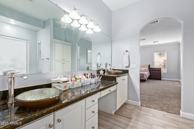 1442 W Laurel Ave, Gilbert, AZ 85233 - bathroom featuring double vanity, baseboards, wood finished floors, and ensuite bath
