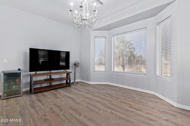 1442 W Laurel Ave, Gilbert, AZ 85233 - living area featuring a chandelier, wood finished floors, beverage cooler, and baseboards