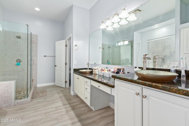 1442 W Laurel Ave, Gilbert, AZ 85233 - bathroom featuring double vanity, a stall shower, wood finished floors, and recessed lighting