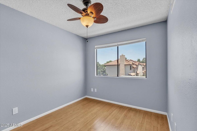 2954 N Oregon St Unit 6, Chandler, AZ 85225 - empty room featuring wood finished floors, a textured ceiling, and a ceiling fan