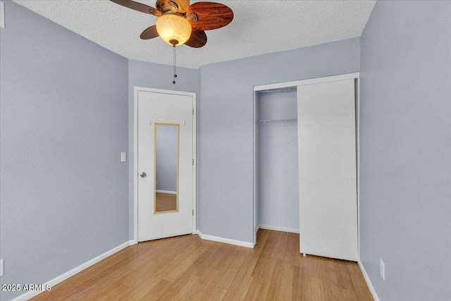 2954 N Oregon St Unit 6, Chandler, AZ 85225 - unfurnished bedroom featuring wood finished floors, a textured ceiling, a closet, and ceiling fan
