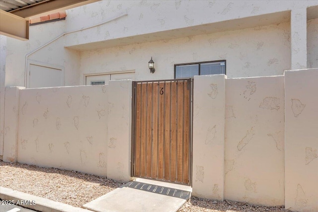 2954 N Oregon St Unit 6, Chandler, AZ 85225 - view of exterior entry featuring stucco siding and a gate