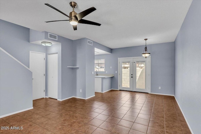 2954 N Oregon St Unit 6, Chandler, AZ 85225 - unfurnished living room featuring a ceiling fan, a textured ceiling, tile patterned flooring, and french doors