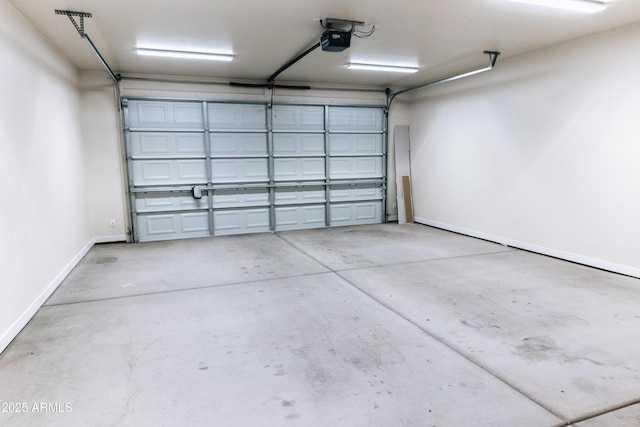 garage with baseboards and a garage door opener