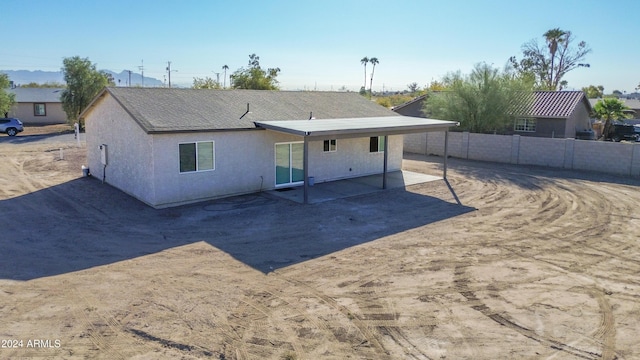 back of house with a patio area, stucco siding, and fence