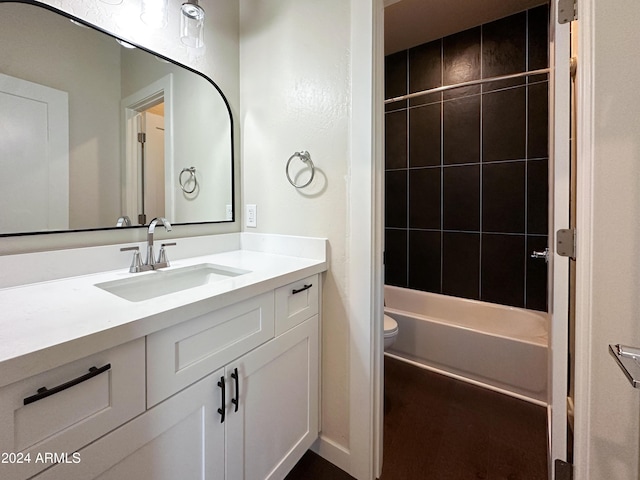 full bath with toilet, vanity, and shower / tub combination