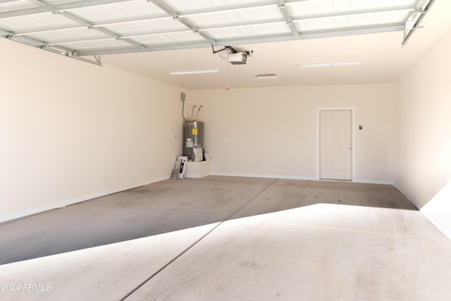 garage with electric water heater and a garage door opener