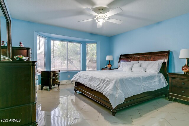 tiled bedroom with ceiling fan