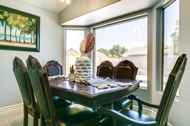 kitchen featuring backsplash, stainless steel appliances, sink, light tile patterned floors, and vaulted ceiling