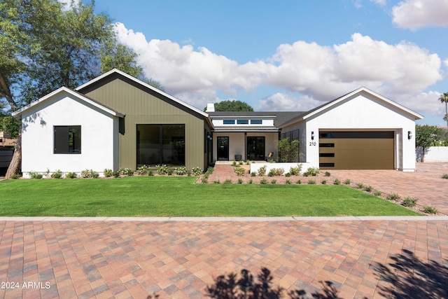 view of front of property with a front lawn and a garage