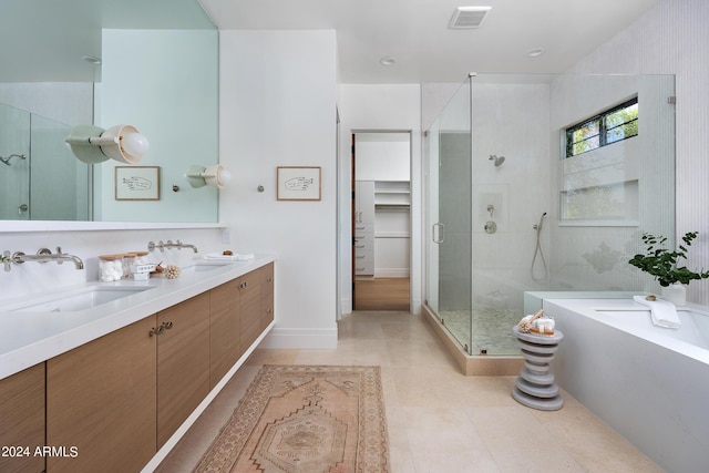 bathroom featuring tile patterned flooring, vanity, and separate shower and tub