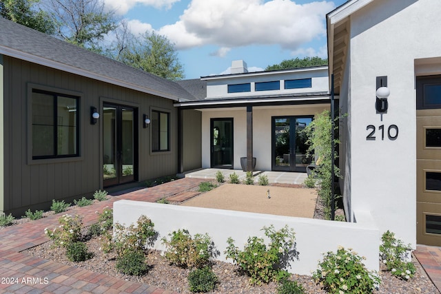 doorway to property featuring french doors and covered porch