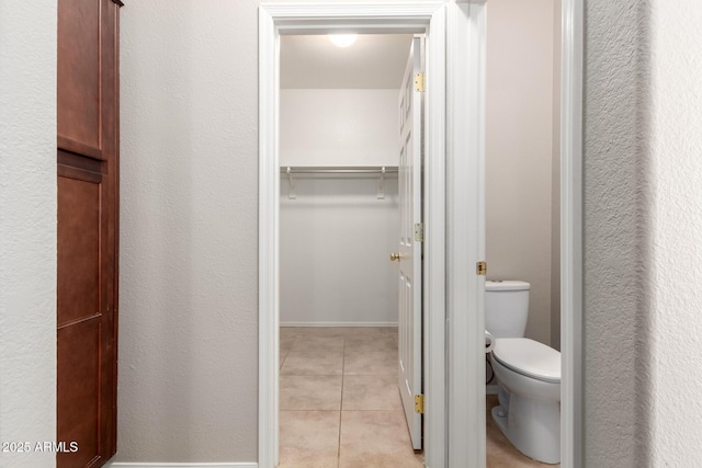 bathroom featuring toilet and tile patterned floors