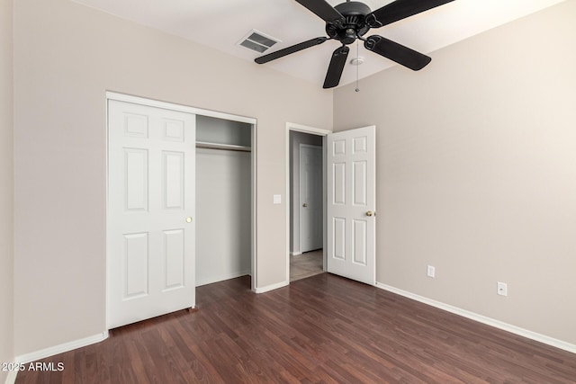 unfurnished bedroom featuring dark wood-style floors, a closet, visible vents, and baseboards