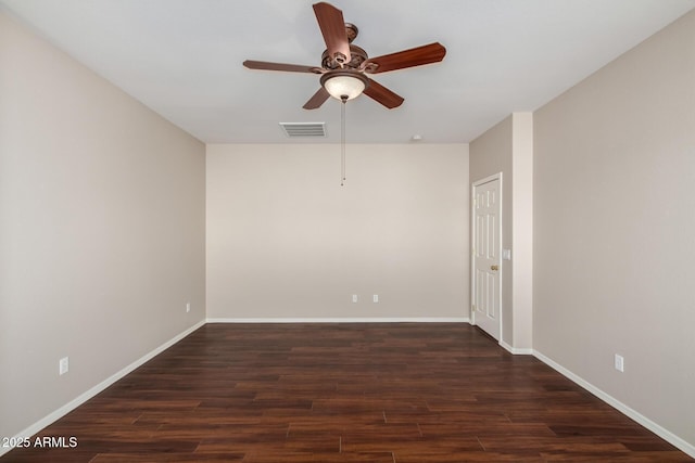 spare room with visible vents, baseboards, and wood finished floors