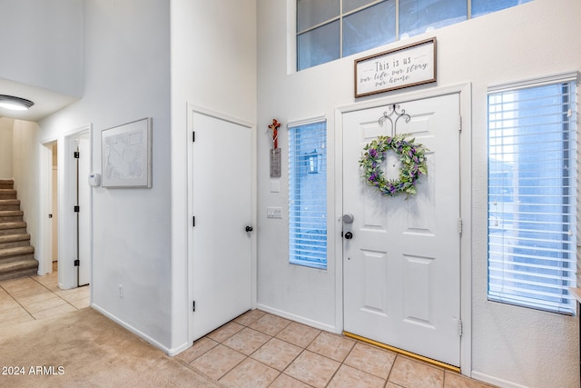 tiled entryway with a high ceiling