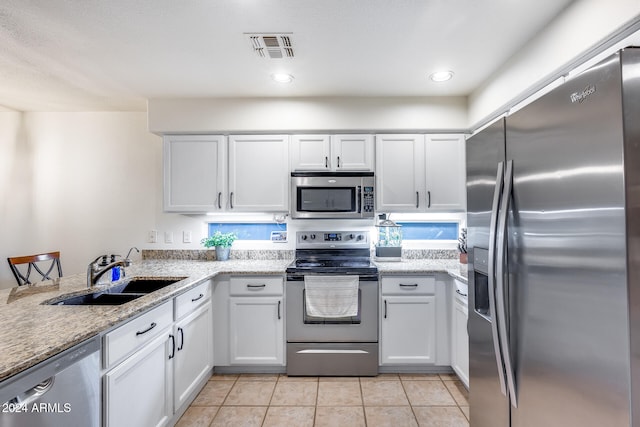 kitchen featuring white cabinets, sink, and appliances with stainless steel finishes