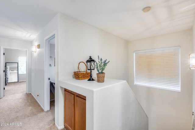 hall featuring light colored carpet