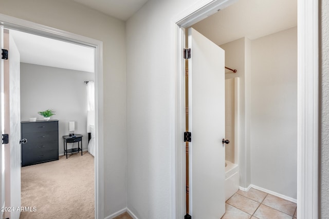 hallway with light colored carpet