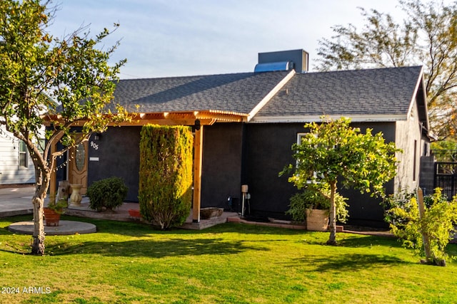 view of front of property with central air condition unit and a front yard