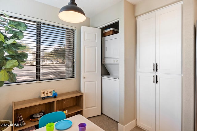 washroom with laundry area and stacked washer and dryer