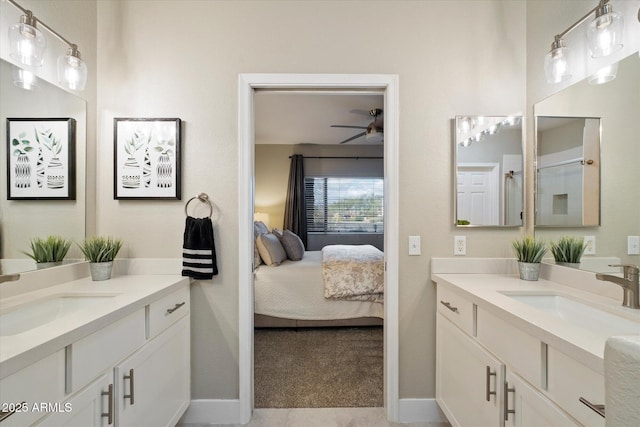 full bathroom with connected bathroom, a ceiling fan, two vanities, and a sink