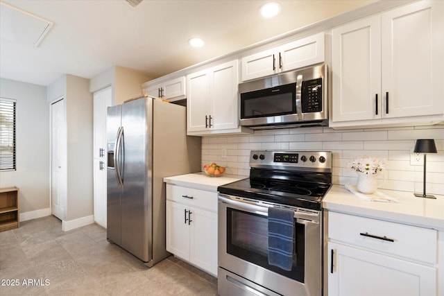 kitchen featuring stainless steel appliances, light countertops, decorative backsplash, and white cabinetry