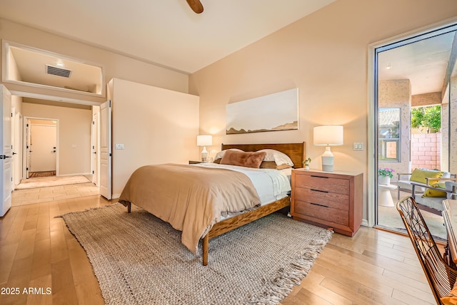 bedroom featuring visible vents, light wood-style flooring, baseboards, and access to outside