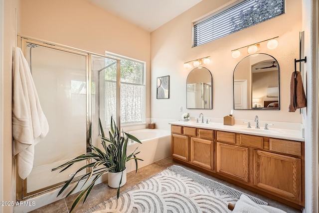 full bathroom with a shower stall, a garden tub, and a sink