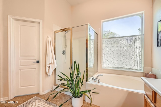 bathroom featuring tile patterned flooring, a shower stall, and a garden tub